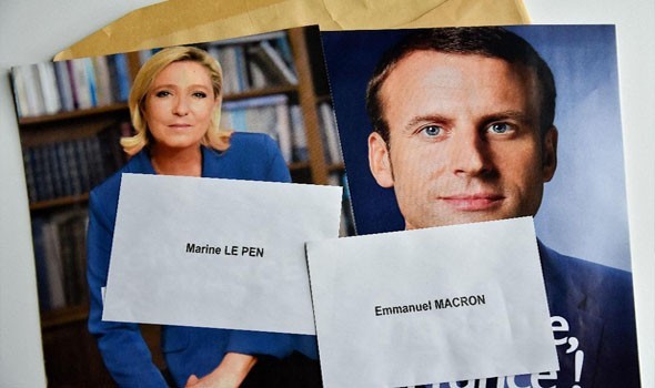 ماكرون يتّهم منافسته مارين لوبن بإشعال حرب أهلية في فرنسا في حال منعها الحجاب في الأماكن العامة